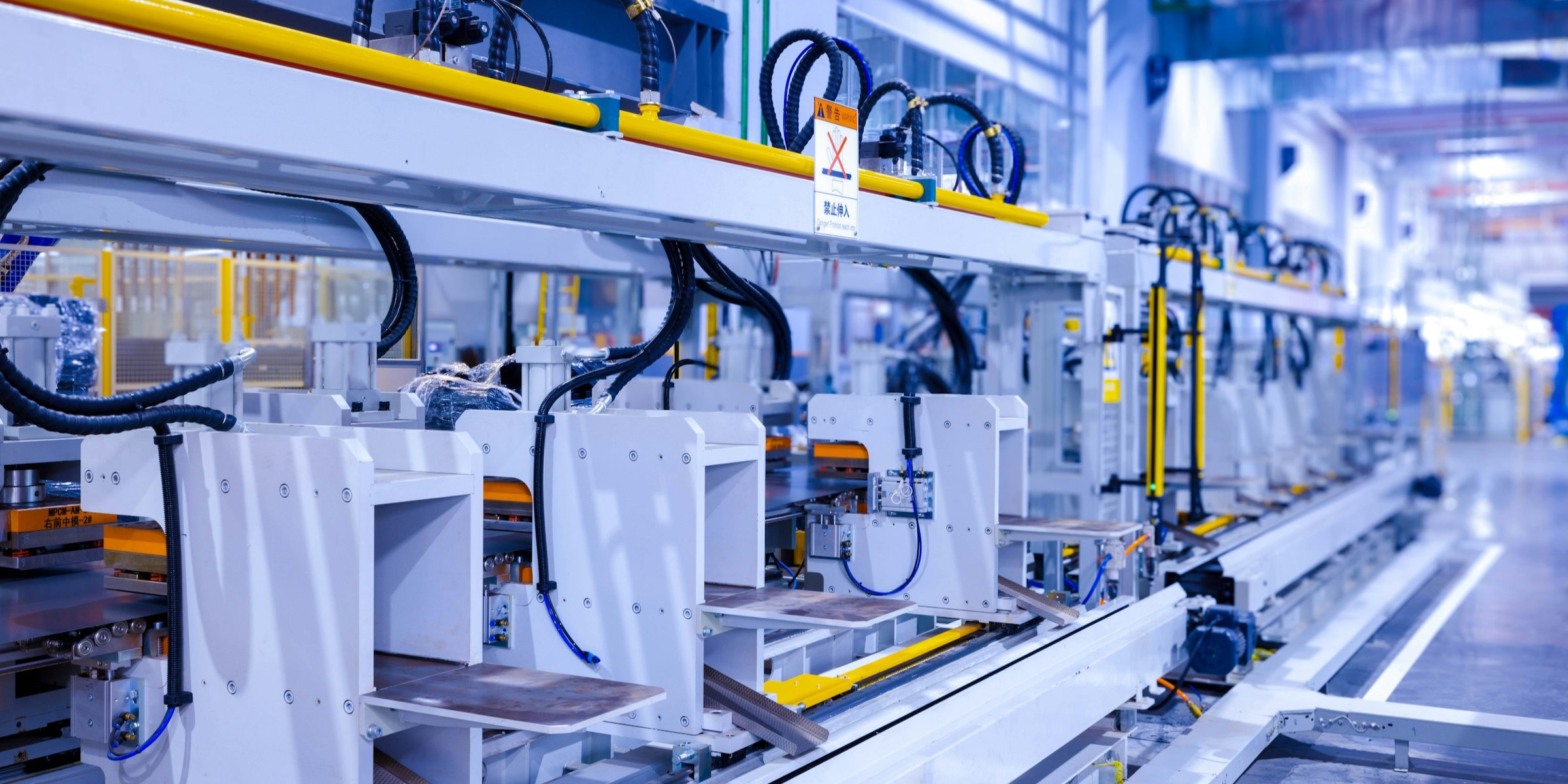 Rows of production machines running on a factory floor