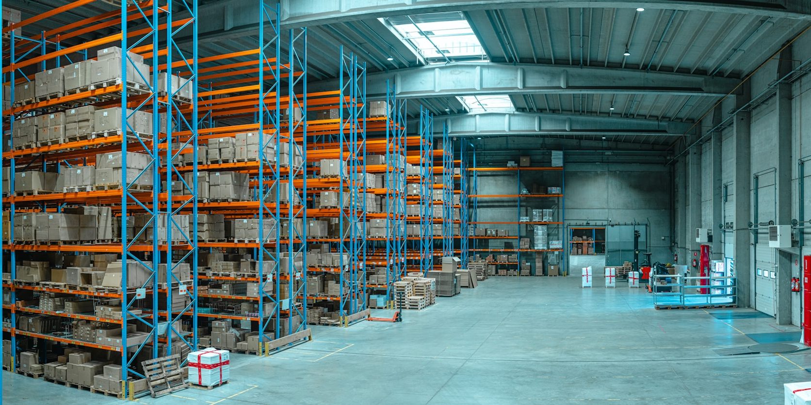 Loaded pallet racking receding down a distribution warehouse